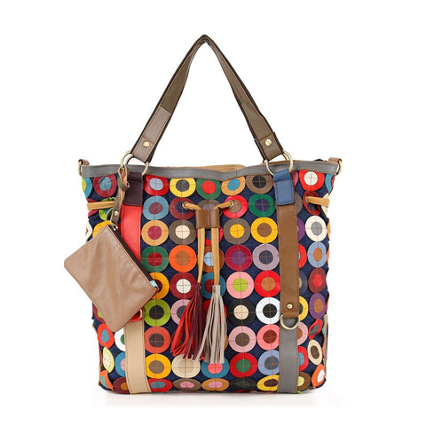 The Genuine Leather Oversized Tote Handbag features a colorful circular geometric pattern, brown handles, leather tassels, an attached tan pouch, and an adjustable shoulder strap for versatile carrying options.