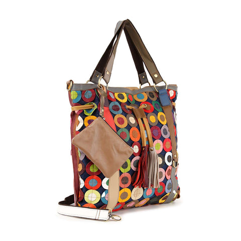 The Genuine Leather Oversized Tote Handbag features a colorful patchwork design with circular patterns, brown leather handles, a matching tassel, detachable brown pouch, and a white adjustable shoulder strap for versatile use.