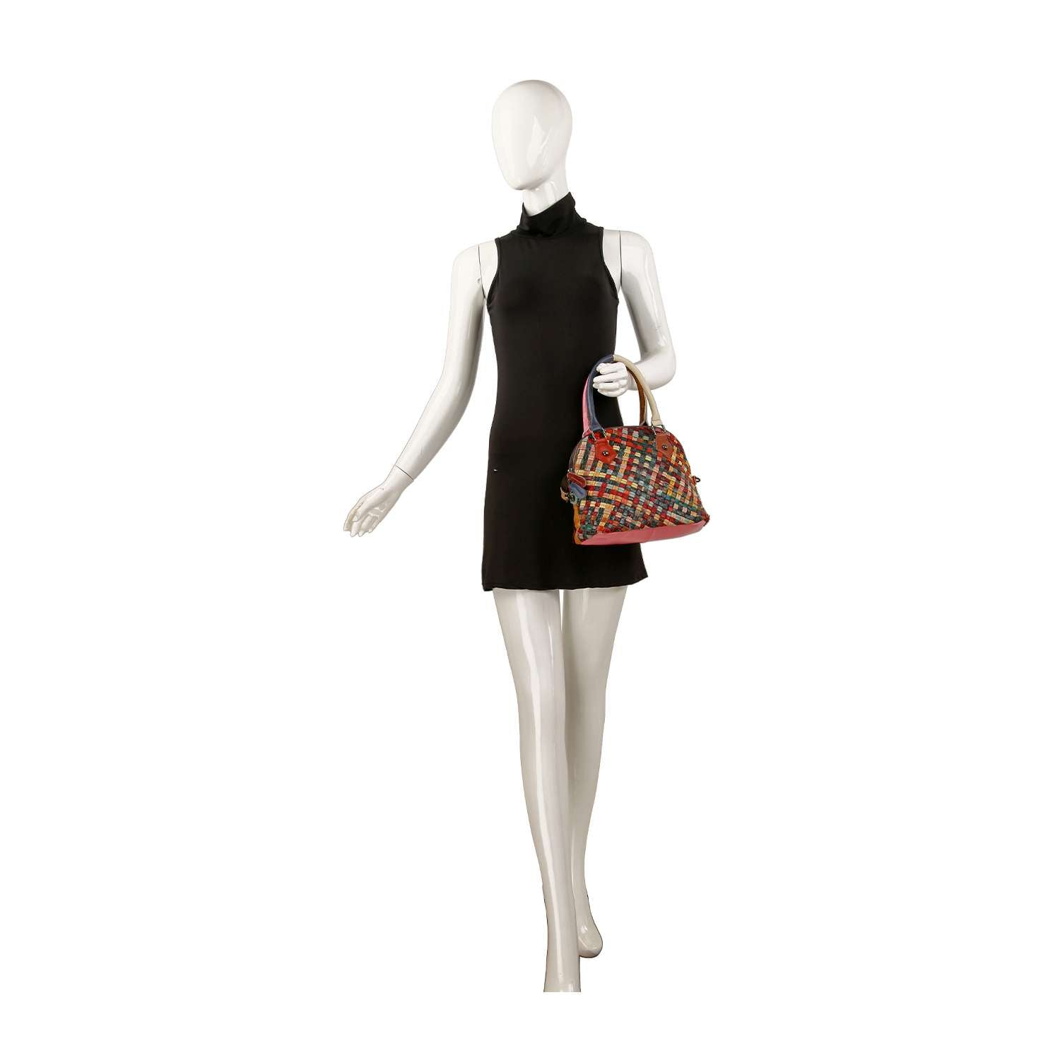 A mannequin in a sleeveless black dress holds the Genuine Leather Colorful Woven Satchel, featuring a plaid pattern and short handle, posed against a plain white background.