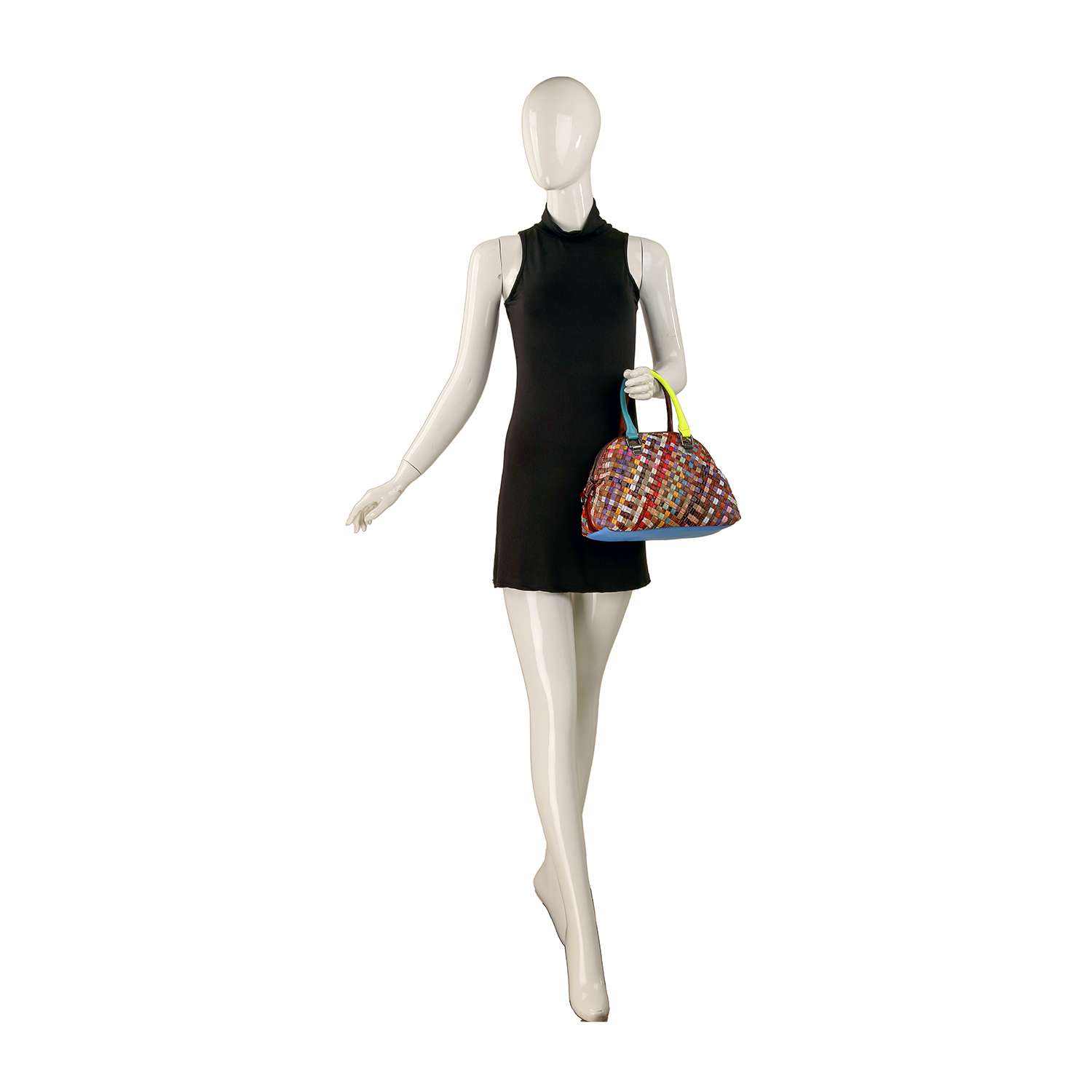 A mannequin in a sleeveless black mini dress holds the Genuine Leather Woven Satchel Handbag, featuring multicolored weave, green handles, and gold-toned hardware, posed against a plain white background.