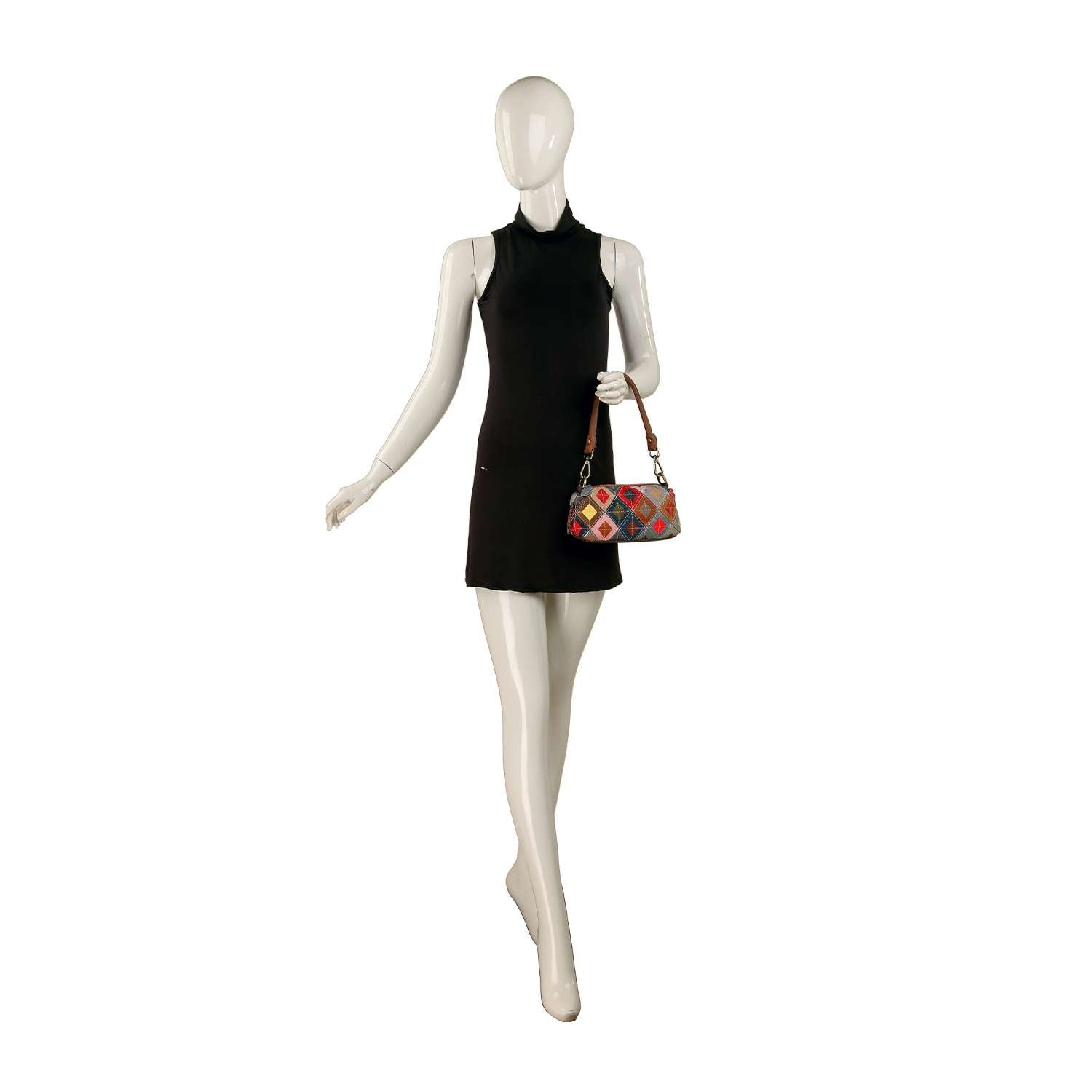 A mannequin in a sleeveless black mini dress holds the Genuine Leather Top Stitch Petite Shoulder Bag against a white background.