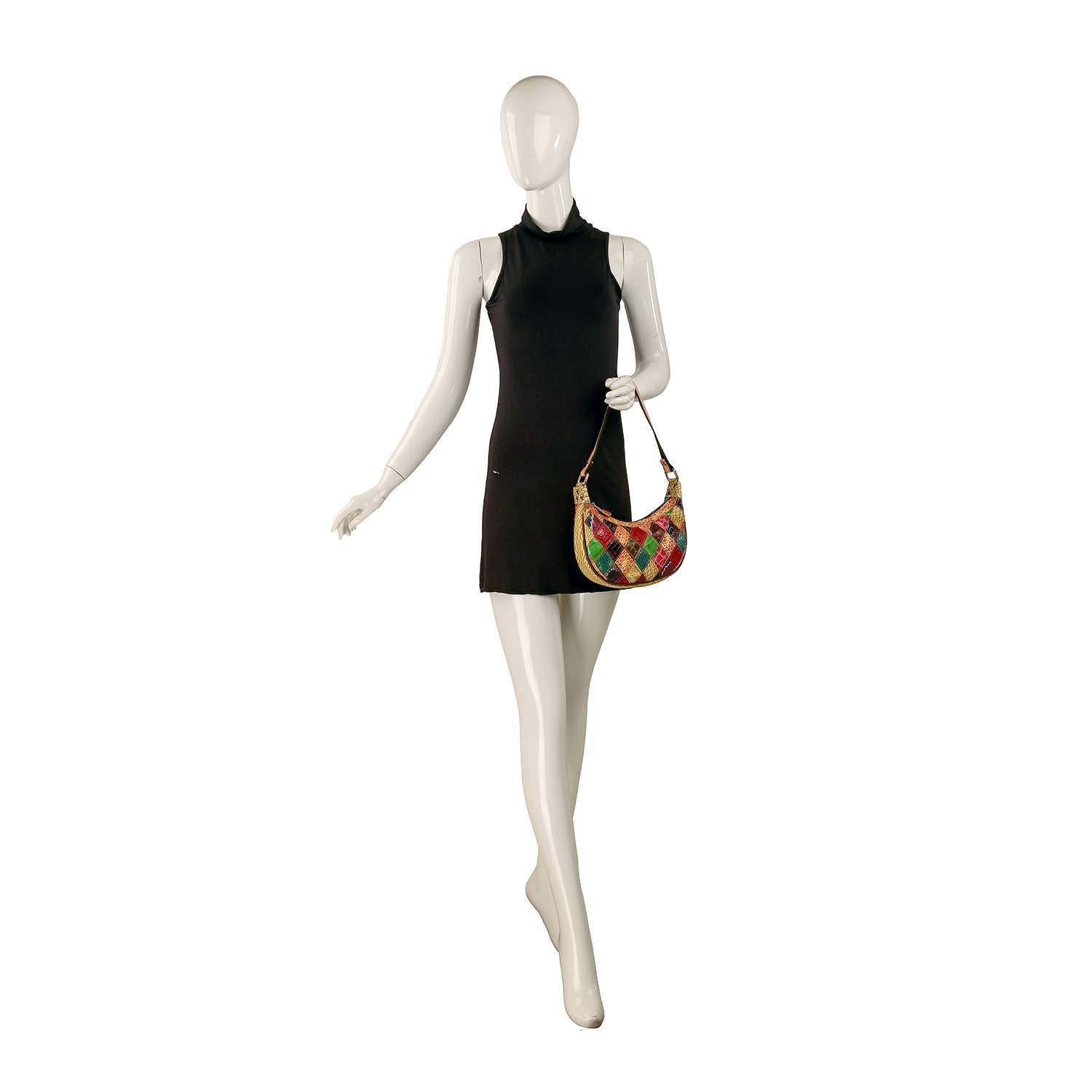 A mannequin in a sleeveless black mini dress holds the Genuine Leather Colorful Patchwork Hobo Bag, a petite, eye-catching accessory that stands out against the plain white background.