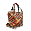 The Genuine Leather Woven Colorful Tote is a handcrafted leather purse with two small handles, a detachable shoulder strap, and a vibrant red, yellow, green, and brown patchwork pattern.