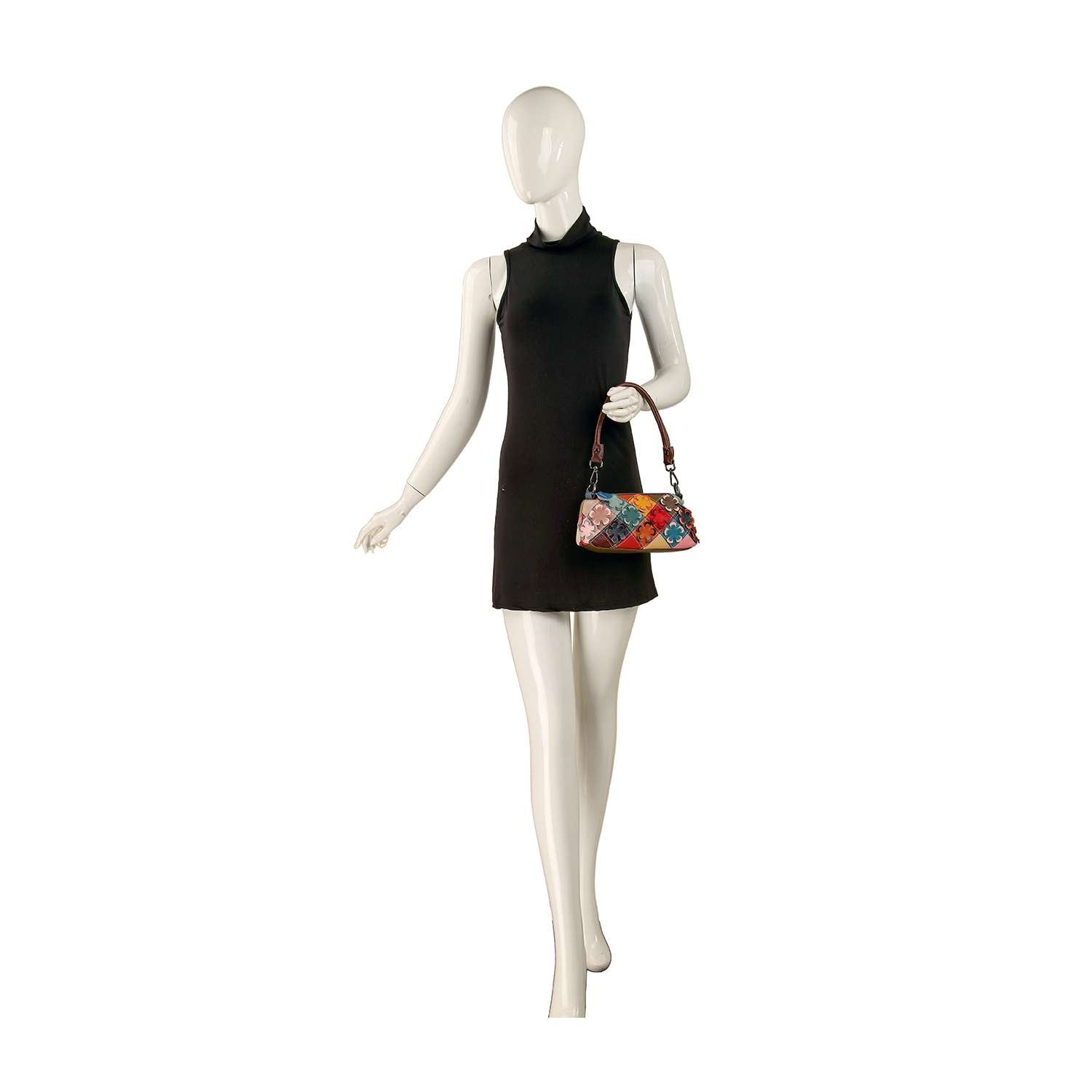 A mannequin in a sleeveless black mini dress holds the Genuine Leather Petite Colorful Floral Design Bag on its left arm against a plain white background.