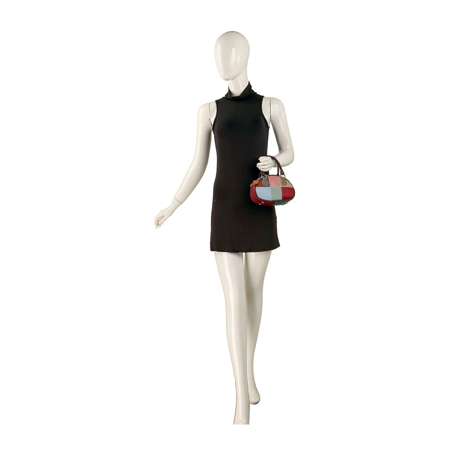 A mannequin in a sleeveless black mini dress holds the Genuine Leather Color Block Hand Tote in red and blue, set against a plain white background.
