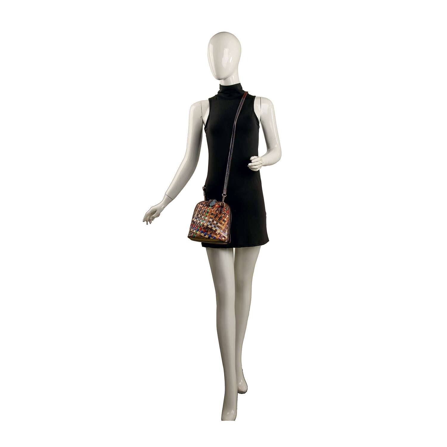 A mannequin in a sleeveless black dress carries the Genuine Leather Woven Crossbody, a small handcrafted bag with a long strap, standing against a plain white background.