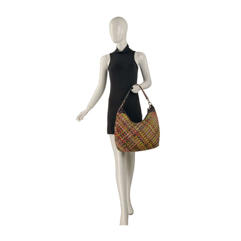 A mannequin in a sleeveless black dress holds the Genuine Leather Woven Hobo Handbag—an eye-catching, multicolored bag with brown handles that's perfect for any occasion.