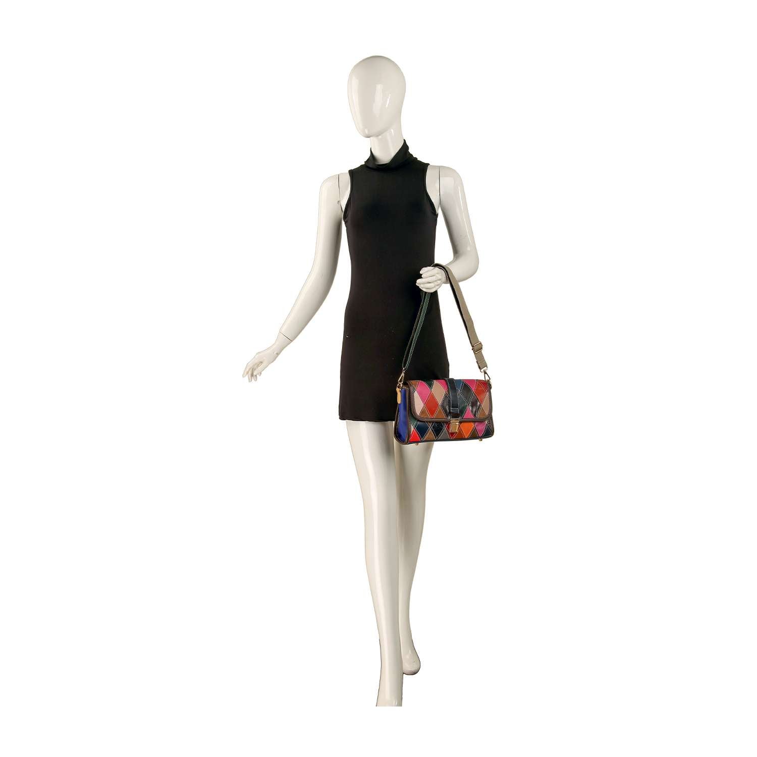 A mannequin in a sleeveless black dress holds the Genuine Leather Patchwork Shoulder Bag, featuring an adjustable strap and vibrant colors, while standing against a white background.
