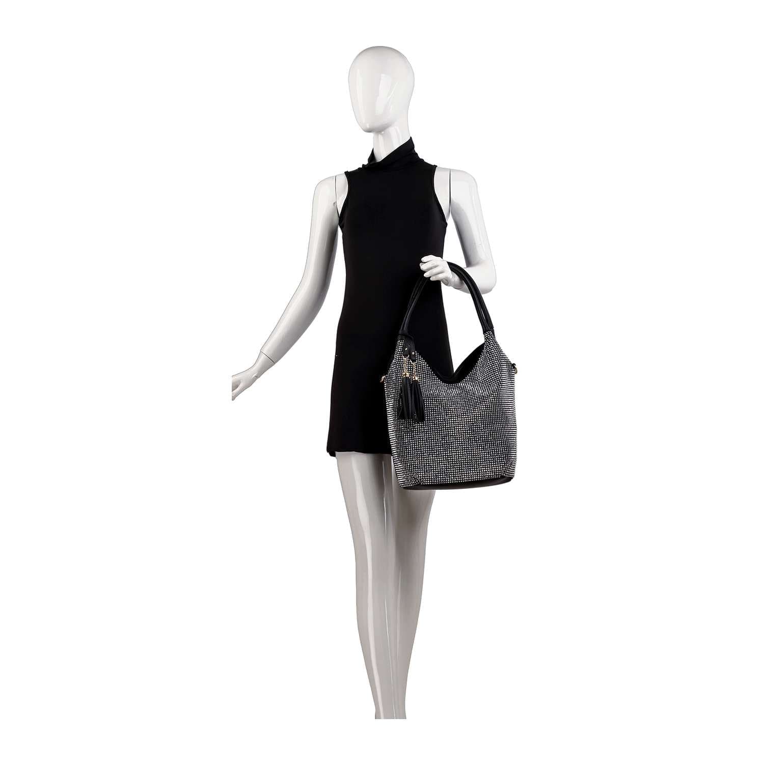 A mannequin in a sleeveless black dress holds the Stunning Sparkling Tall Shoulder Bag, a large gray faux leather shoulder bag with black handles and a tassel accent, posed against a white background.