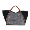The Rhinestone Denim Unique Fashion Tote features black fabric, brown handles and trim, and a front panel with sparkling rhinestones. Spacious and tablet-friendly, its perfect for carrying your essentials in style.
