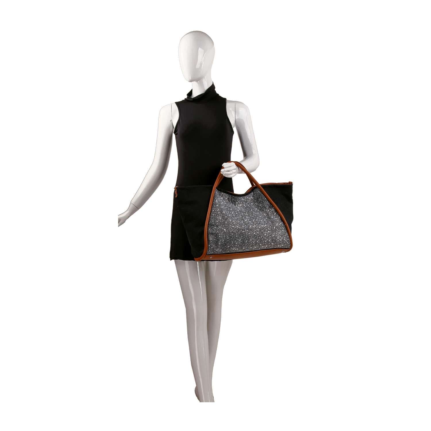 A faceless mannequin in a sleeveless black dress holds the Rhinestone Denim Unique Fashion Tote, featuring brown handles and a sparkling silver front panel. The background is plain white.