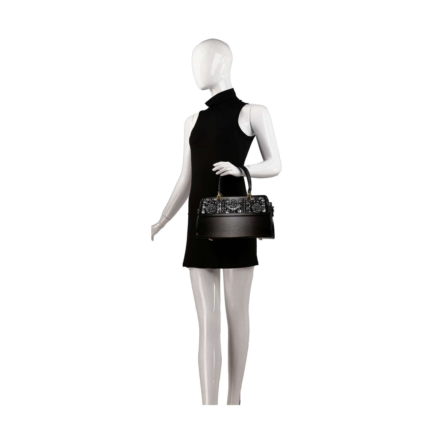 A mannequin in a sleeveless black dress holds the Sparkling Patent Decorative Hand Tote, standing against a plain white background.