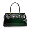 The Sparkling Patent Decorative Hand Tote features glossy dark green faux leather, black handles, gold hardware, and silver floral with crystal embellishments on the front flap.