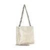 The Metal Mesh Evening Bag features a netted, metallic silver texture and a thick silver chain strap. Displayed at an angle on a plain white background, the bag appears elegant and shiny.