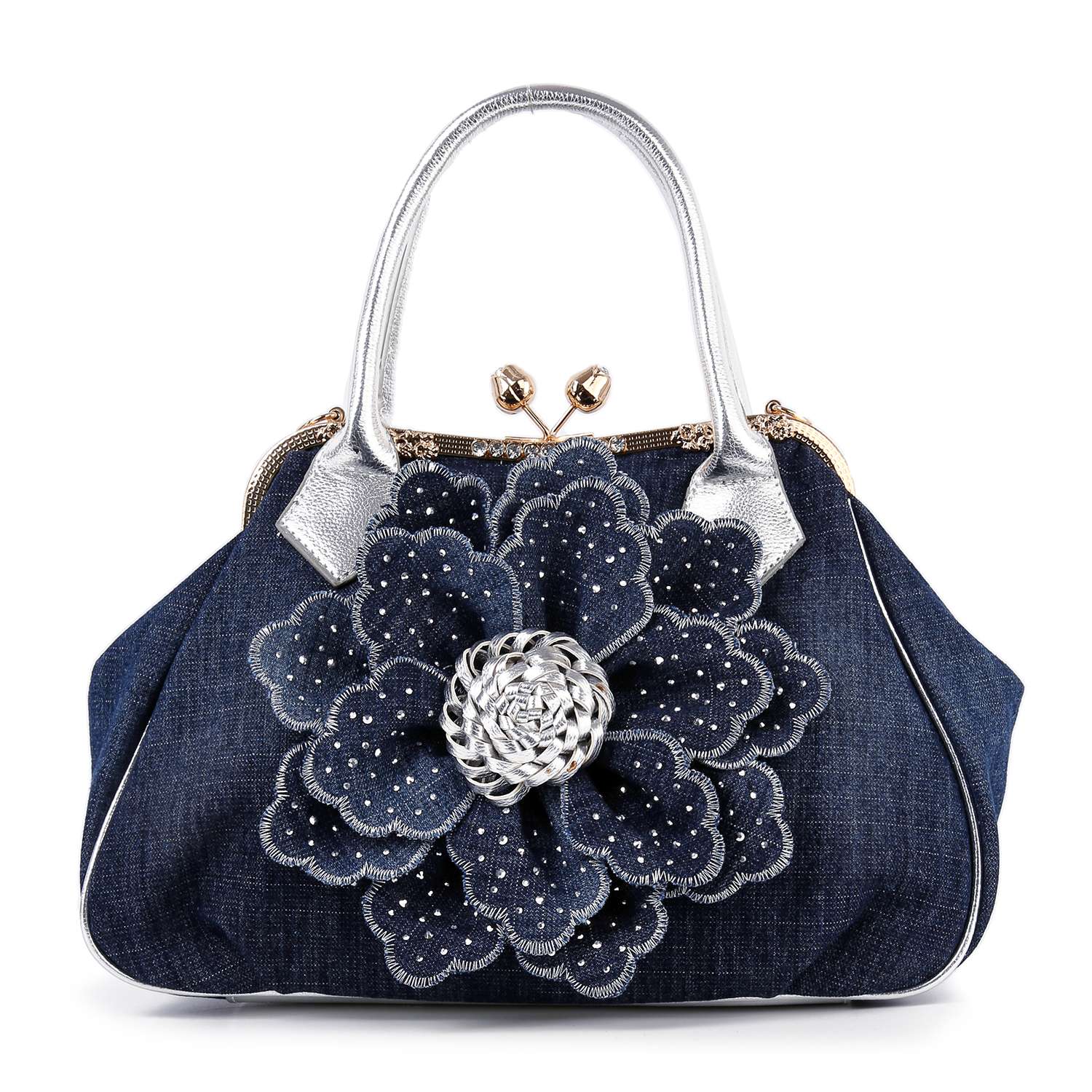 The Raised Flower Metal Frame Hand Tote is a vintage-chic denim handbag with metallic silver handles and a large, layered denim flower with a studded silver center on the front.