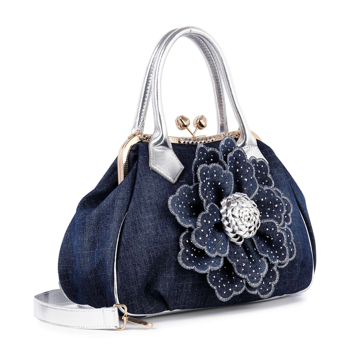 The Raised Flower Metal Frame Hand Tote is a vintage-chic denim bag with metallic silver handles, a large decorative denim flower with silver accents, and front studs—a stylish and spacious choice for any occasion.