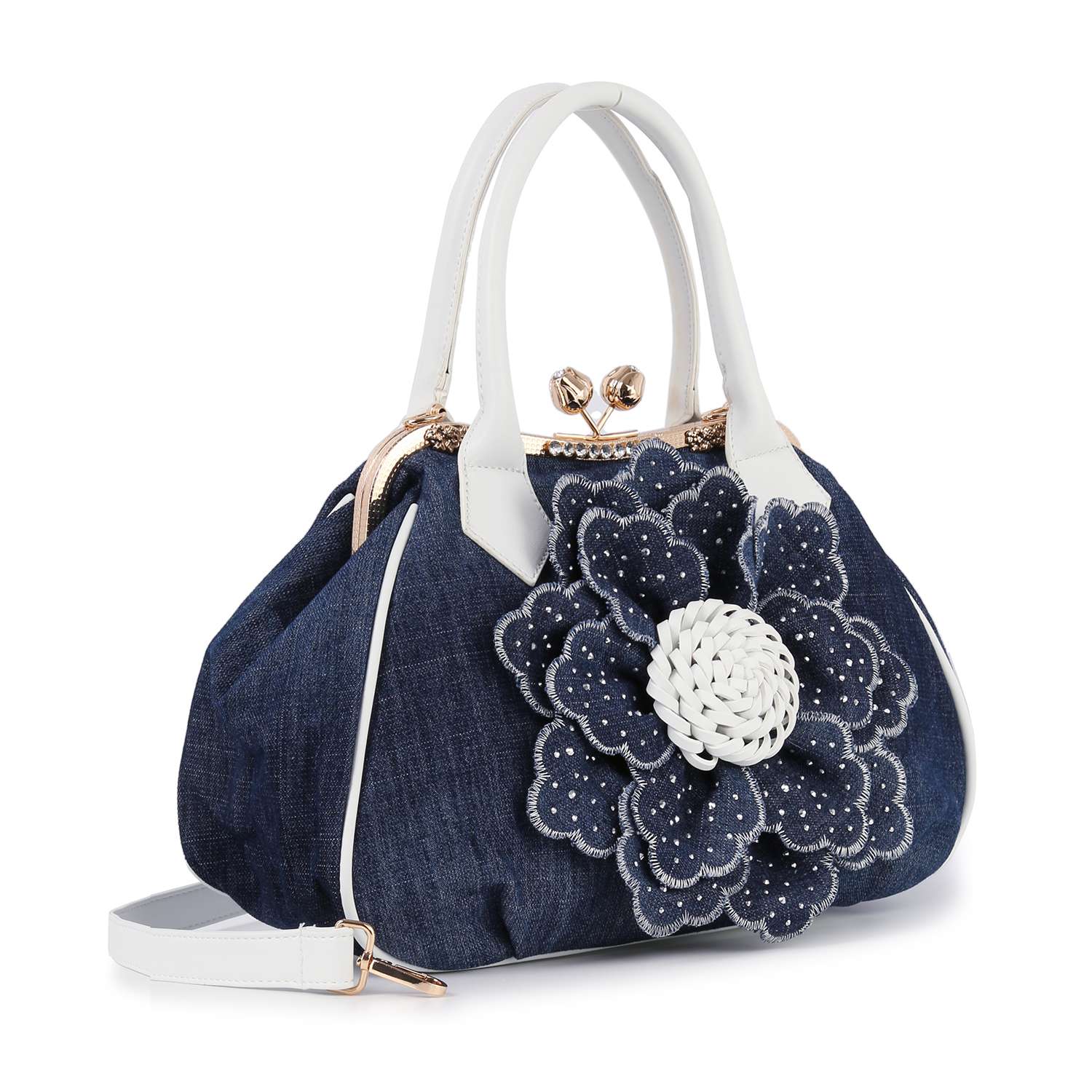 The Raised Flower Metal Frame Hand Tote is a dark blue denim bag with white handles, trim, and stitching. It features a large layered fabric flower, metal clasp closure, and an adjustable shoulder strap for vintage-chic style.