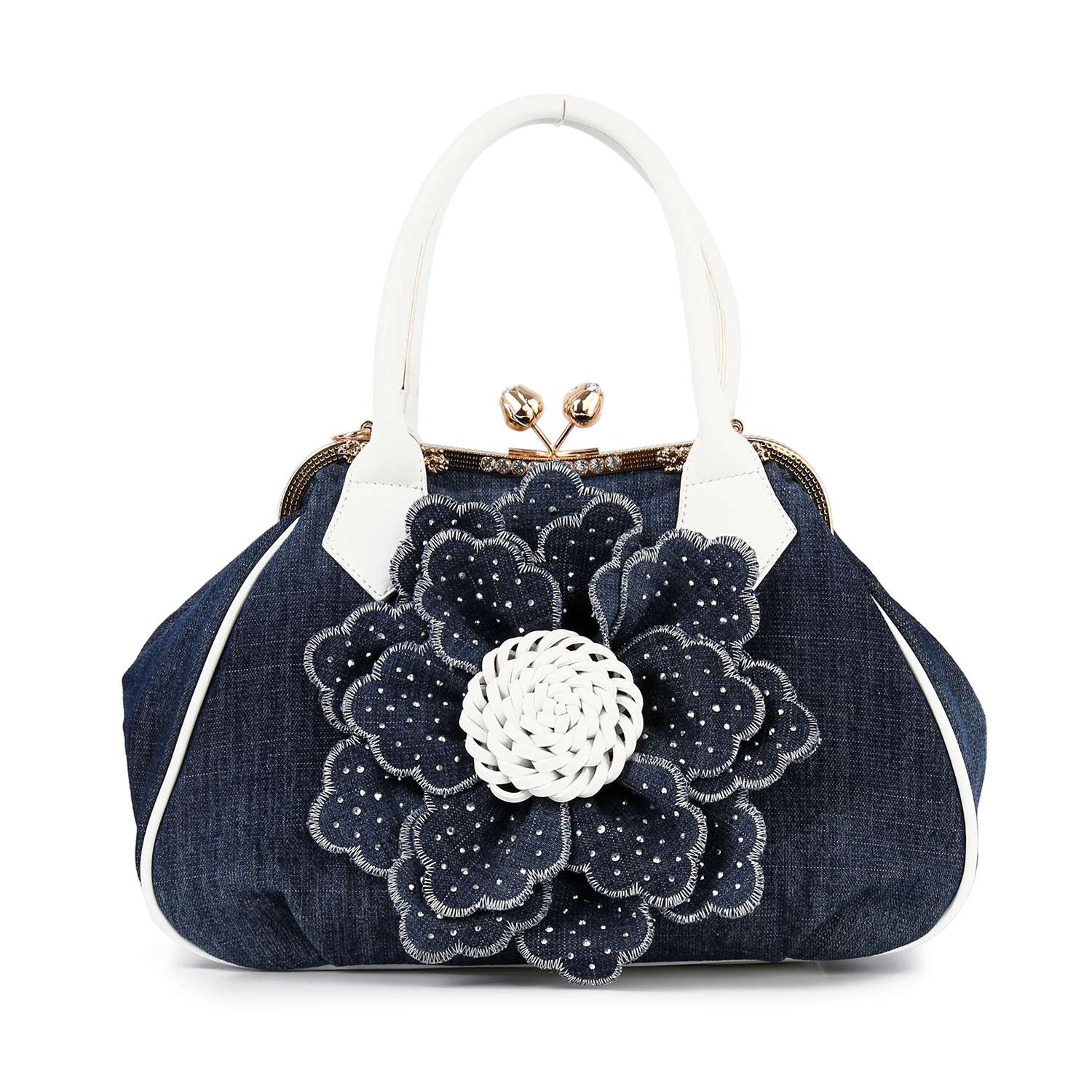 The Raised Flower Metal Frame Hand Tote is a denim handbag with white handles and a large, layered fabric flower with small white dots on the front, finished with a vintage-chic top clasp closure.
