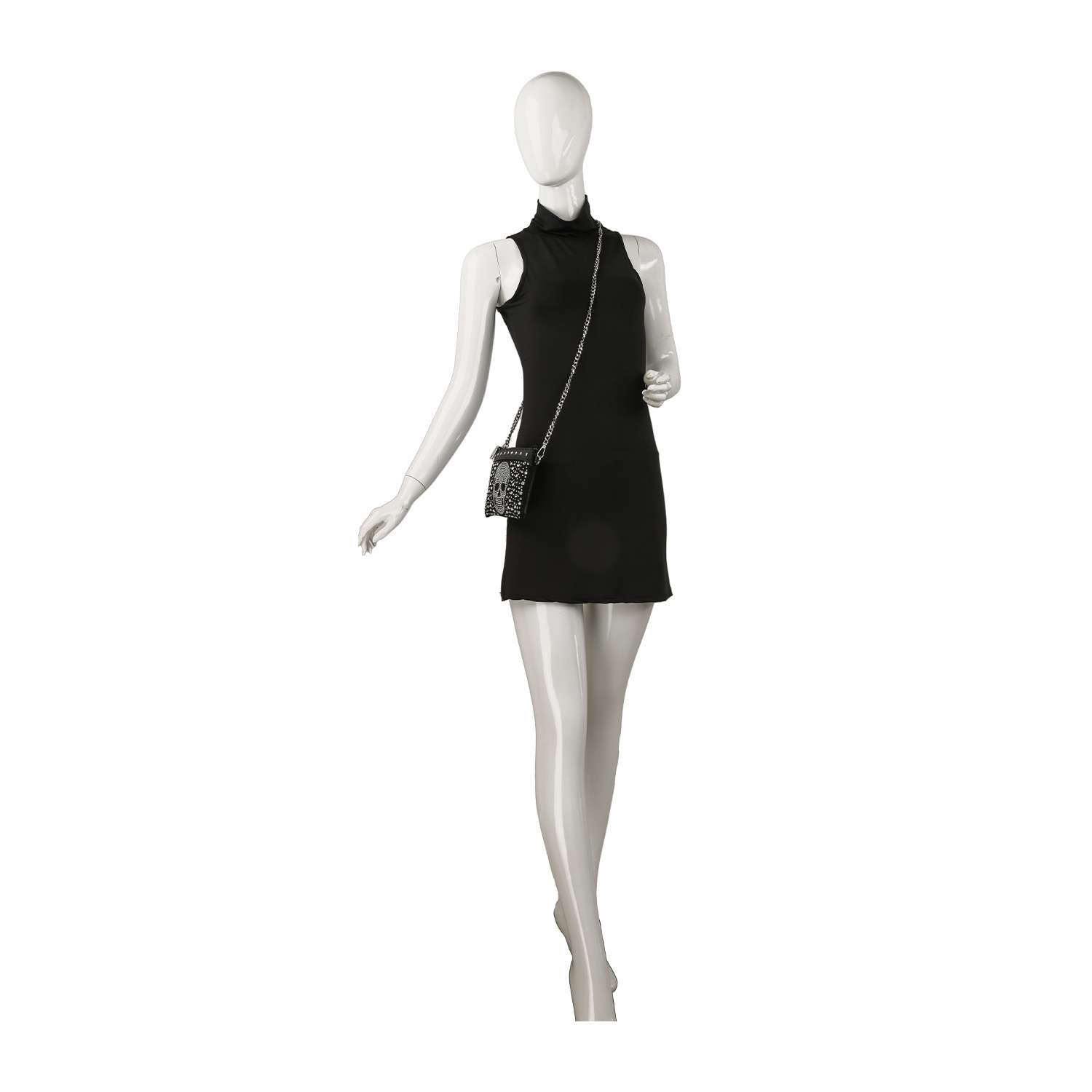 A white mannequin wears a sleeveless black mini dress and the Petite Rhinestone Skull Shoulder Bag, featuring a chain strap, posed against a plain white background.