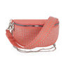 The Stylish Studded Crossbody Bag features coral pink faux leather, silver studs, a wide studded strap, zipper closure, and a silver chain accent.