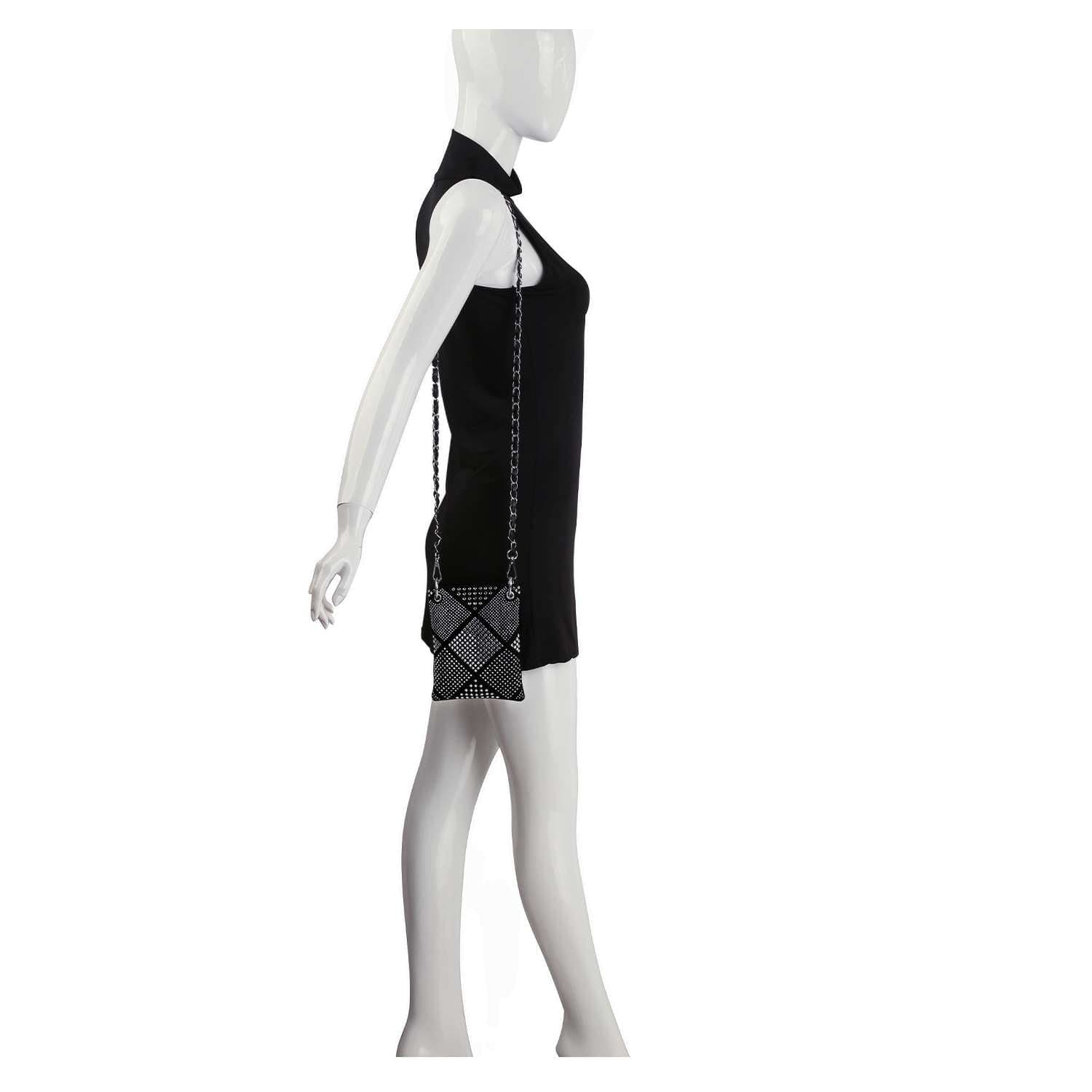 A mannequin in a sleeveless black dress is shown in side profile, wearing the Diamond Design Petite Crossbody Sling with a chain strap against a plain white background.