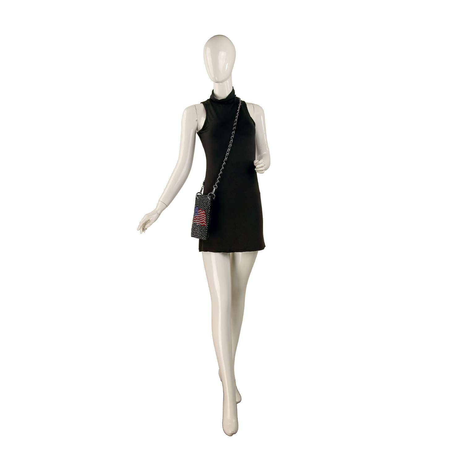 A mannequin in a sleeveless black mini dress showcases the *New Size* Petite Rhinestone Bling Flag Crossbody Sling, adding patriotic flair to the chic ensemble against a white background.