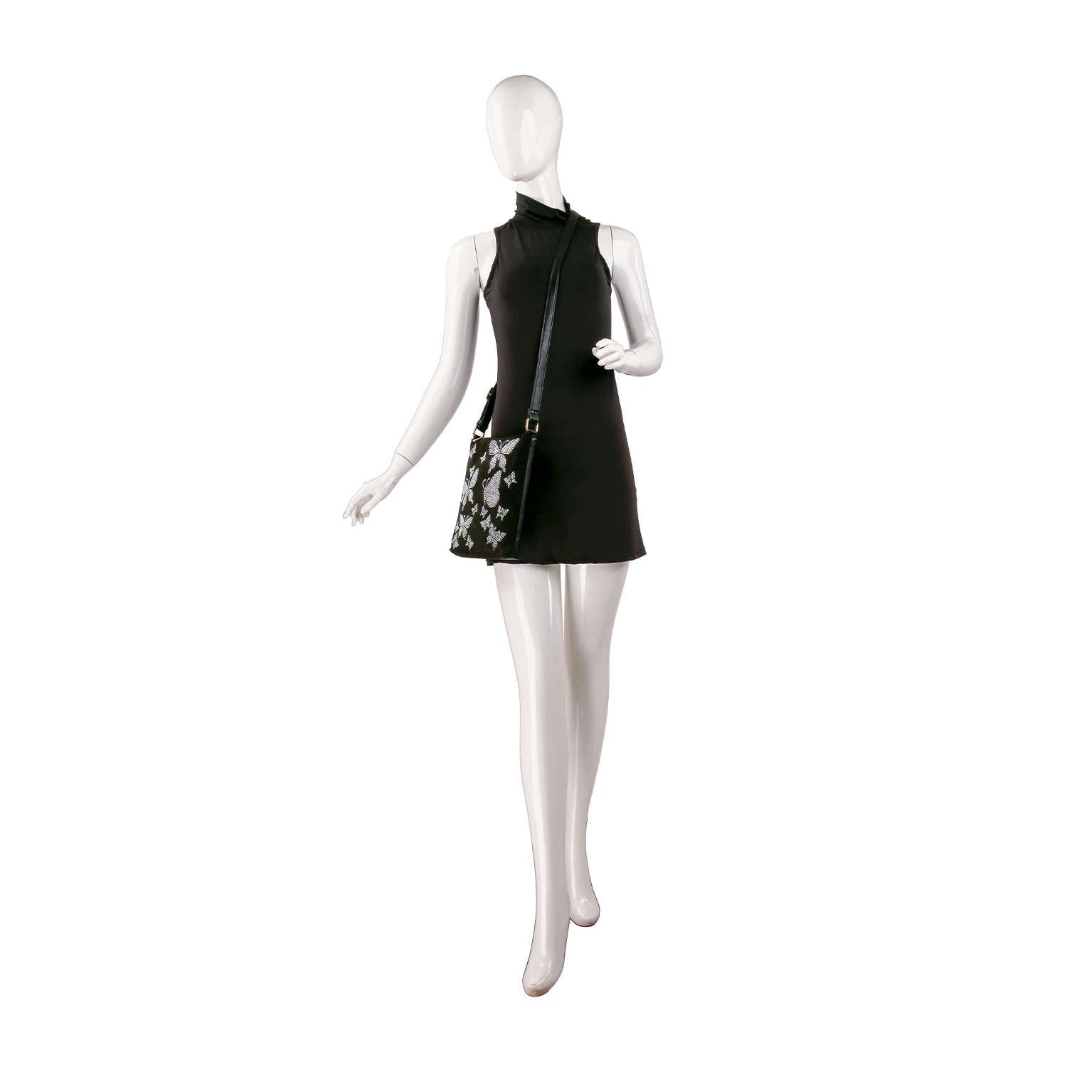 A faceless mannequin in a sleeveless black mini dress carries the Floral Rhinestone Design Petite Crossbody Sling, featuring a white floral pattern, posed against a plain white background.