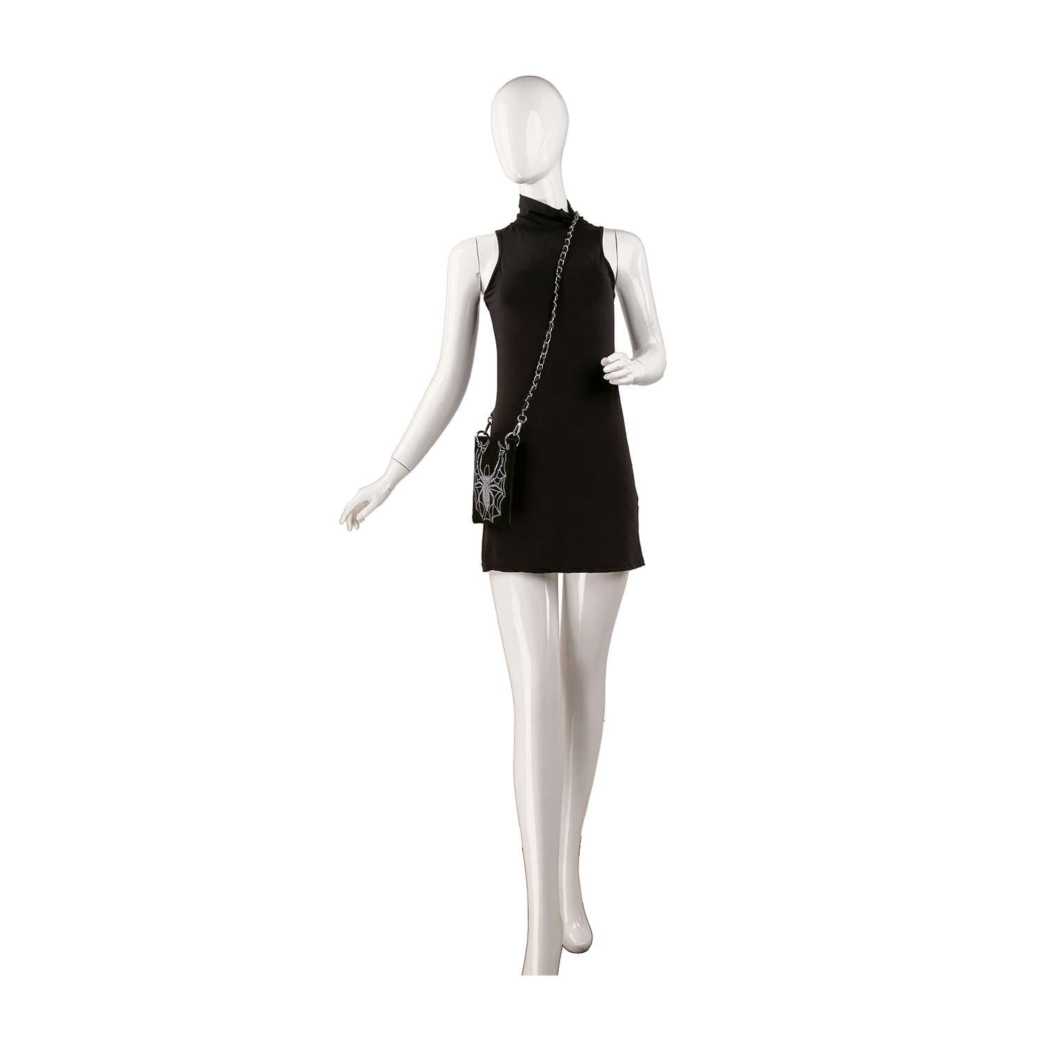A mannequin in a sleeveless black mini dress stands on one leg with arms slightly bent, styled with the Rhinestone Spider Web Design Petite Crossbody Sling featuring a chain strap.