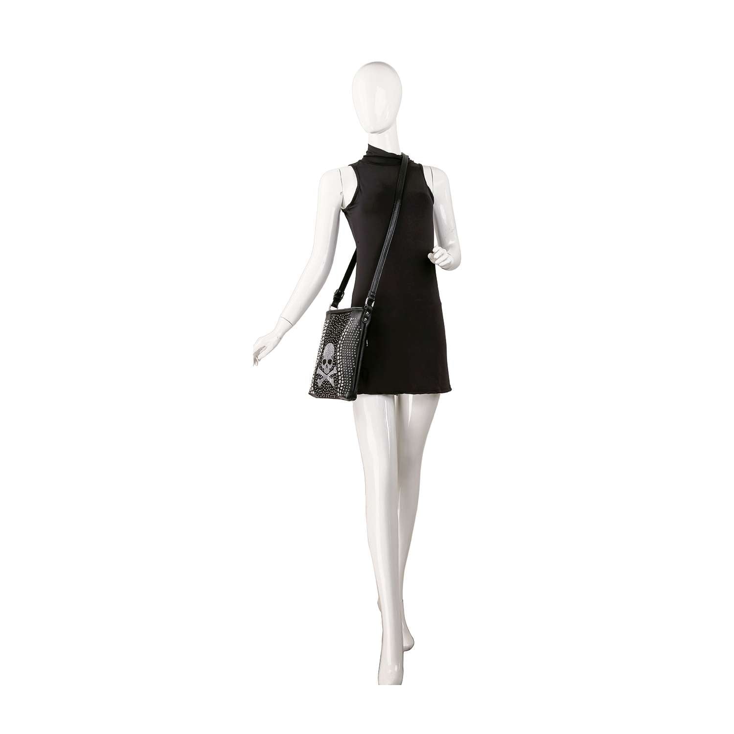 A white mannequin wears a sleeveless black mini dress and the Skull Rhinestone Crossbody Sling, featuring a textured pattern, standing against a plain white background.