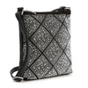 The Super Sparkling Crossbody Sling is a black faux leather bag with a diamond pattern of silver studs, a slim adjustable strap, and a zippered top—ideal for staying hands free on the go.