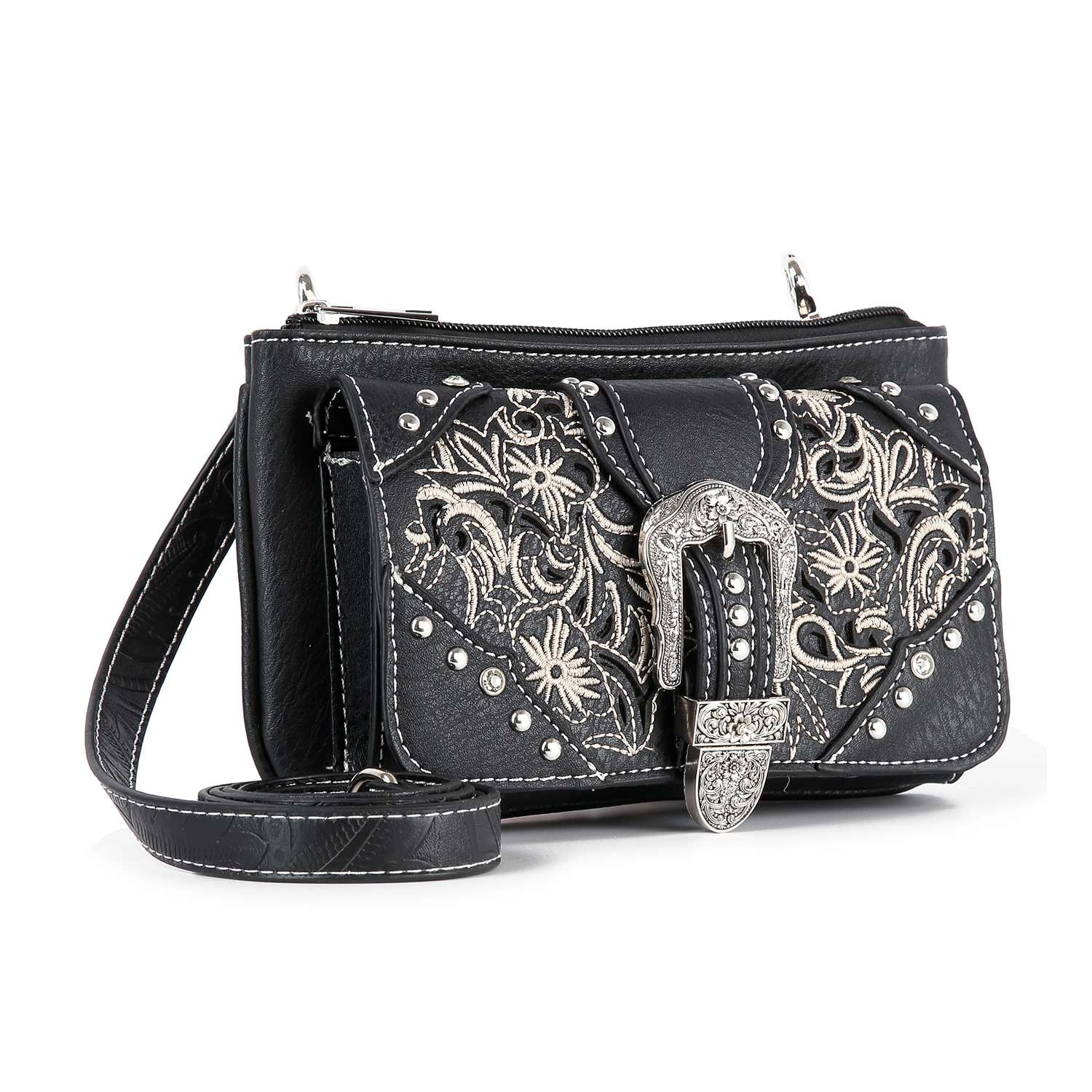 The Western Buckle Design Petite Crossbody Sling is a black faux leather bag with silver floral embroidery, decorative studs, and a large ornate buckle. It features a detachable strap, zipper closure, and fits a tablet for convenience.