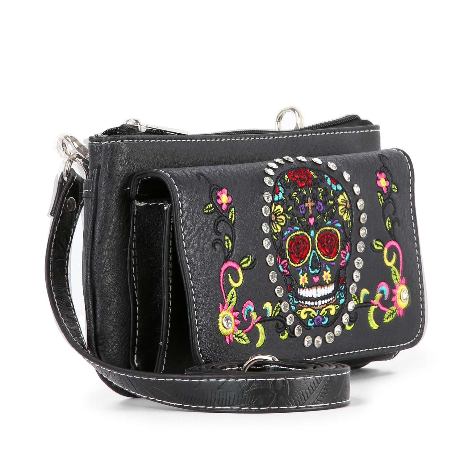 The Colorful Sugar Skull Petite Crossbody Sling is a black leather western bag with white stitching, colorful embroidered flowers, a vibrant sugar skull design, metal studs around the motif, and an adjustable strap for comfort.