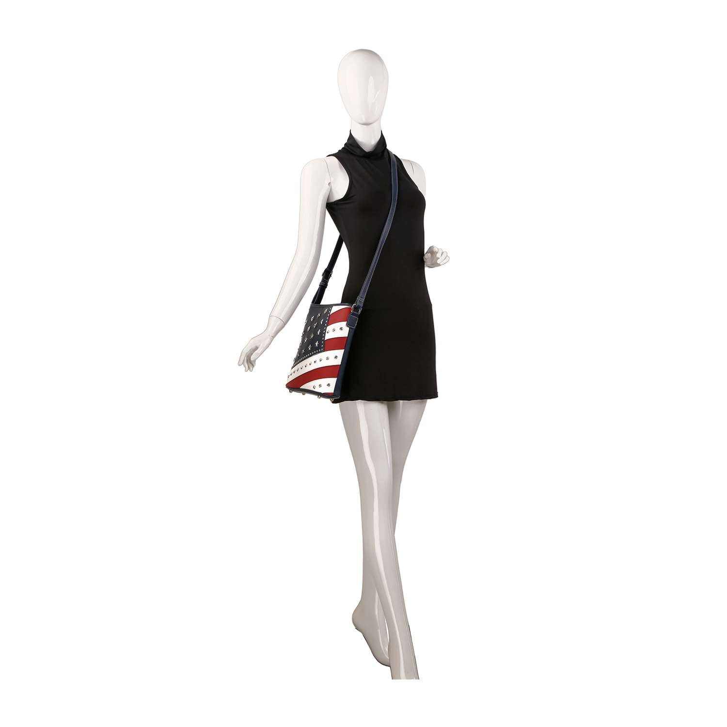 A mannequin in a sleeveless black dress stands with one arm slightly raised, wearing the Bold Flag Design Crossbody Sling.