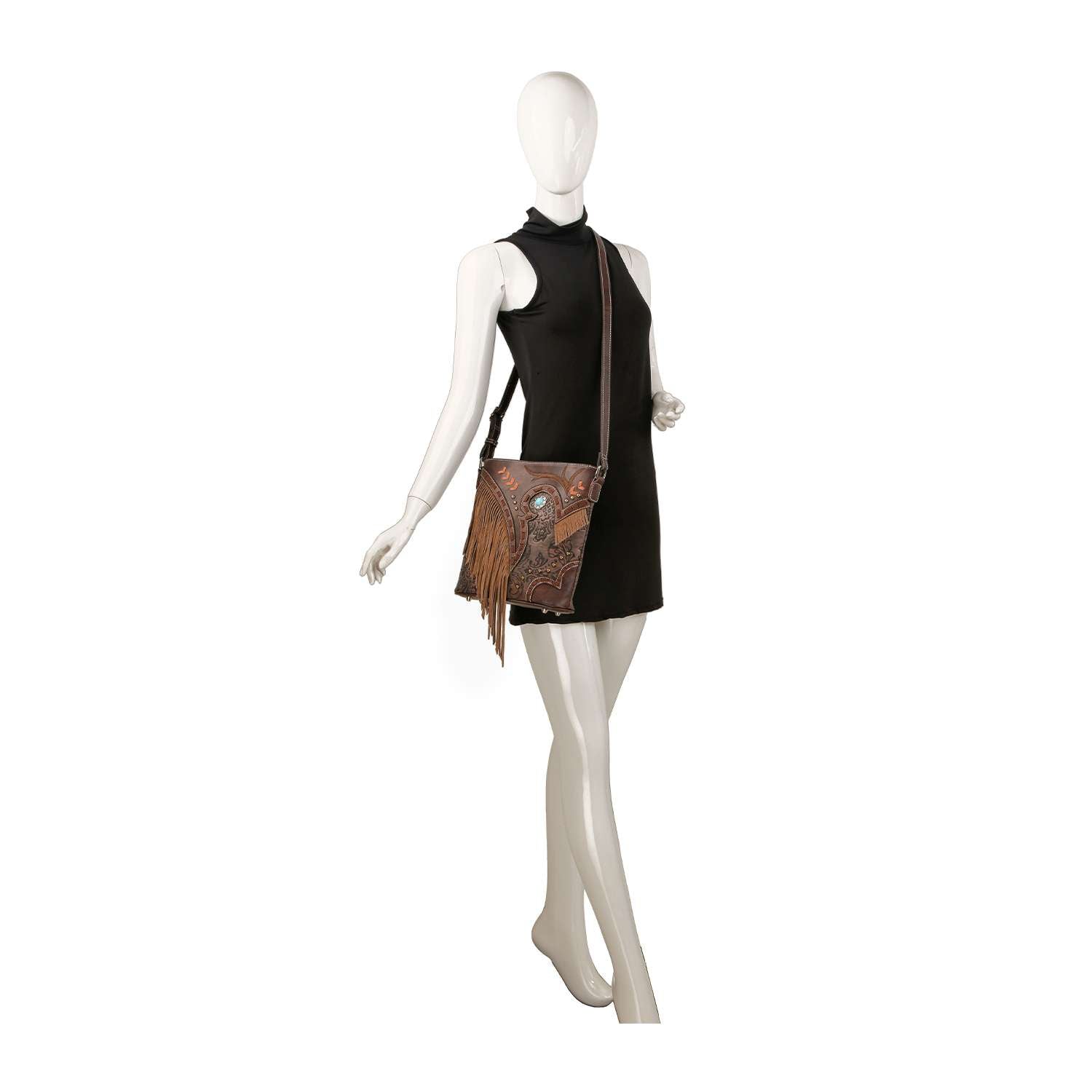 A mannequin in a sleeveless black dress showcases the Western Fringe Design Crossbody Sling, a faux leather bag with fringe and decorative details, hanging at hip height on the left side for a rustic touch.