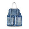 The Rhinestone Basketweave Drawstring Backpack is a stylish blue bag with silver hardware, a flap adorned with silver studs, two front straps, silver handles, and woven silver and blue basketweave front pockets.