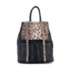 The Rhinestone Accent Fashion Backpack is a black faux leather bag with two front pockets and a flap closure. The leopard print flap and straps are embellished with silver studs. Features adjustable shoulder straps and a top handle.