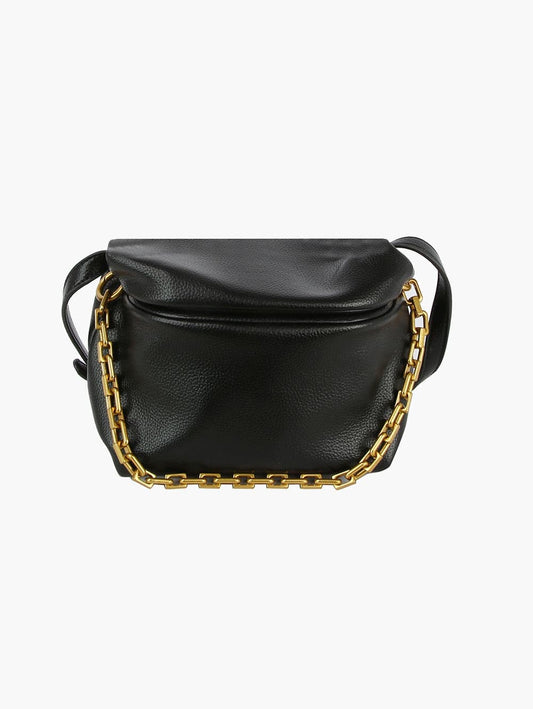 The Chain Accented Front Flap Shoulder Bag features black faux leather, a flap closure, chunky gold-toned hardware chain detail on the front, and an adjustable strap, shown against a plain white background.