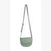 The Top Flap Petite Crossbody Bag is a light green faux leather bag with an adjustable strap and rounded flap secured by a small gold clasp, shown against a plain white background.