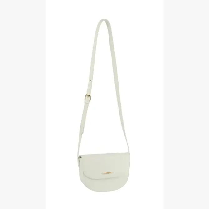 The Top Flap Petite Crossbody Bag is a small, light beige faux leather bag with a long adjustable strap and flap closure, shown against a plain white background.