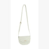 The Top Flap Petite Crossbody Bag is a small, light beige faux leather bag with a long adjustable strap and flap closure, shown against a plain white background.