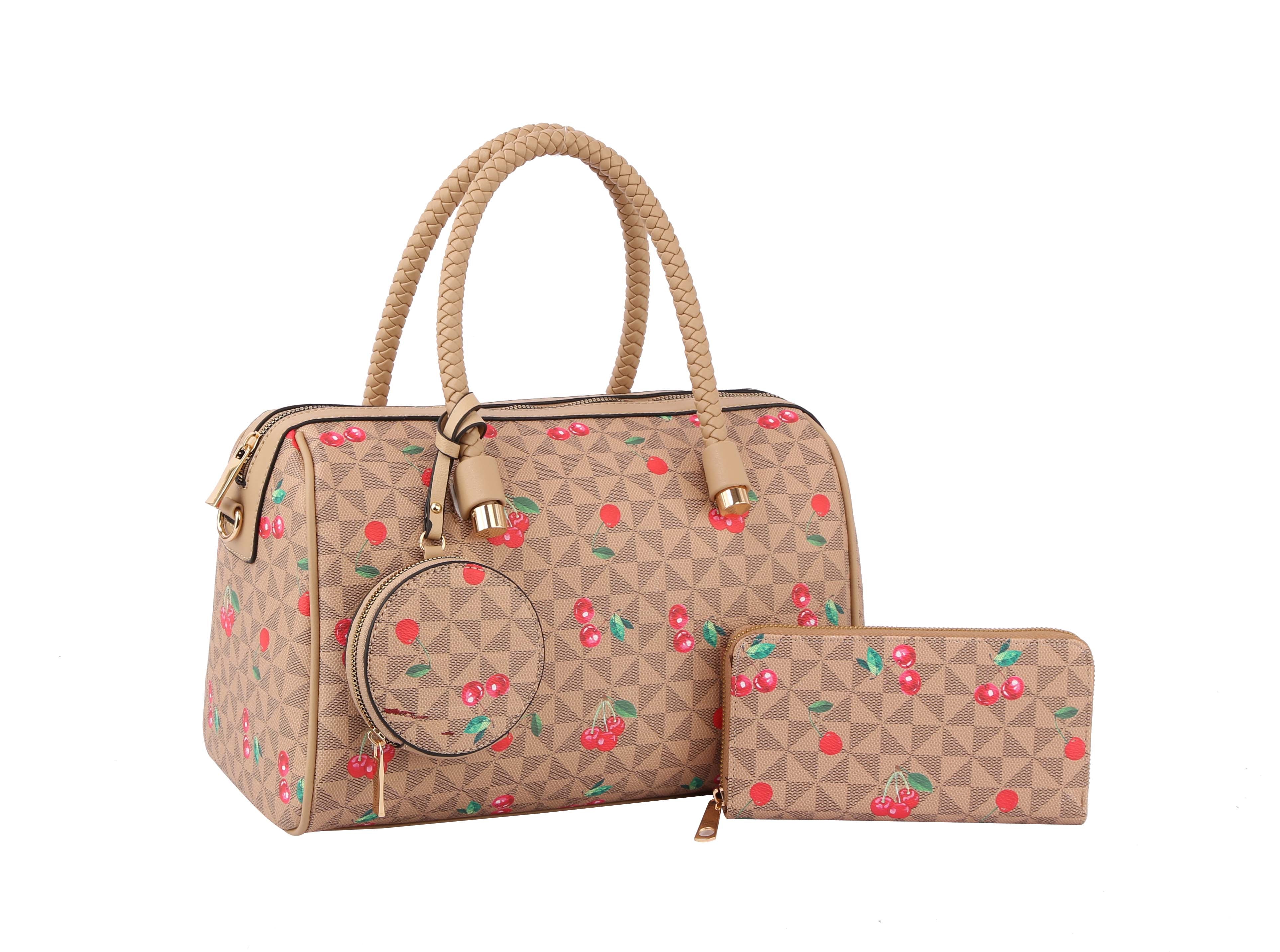 The Signature Cherry Print Satchel Set features a beige faux leather handbag with a detachable strap and geometric pattern, paired with a zip-around wallet decorated with red cherry prints and gold-tone hardware on a white background.