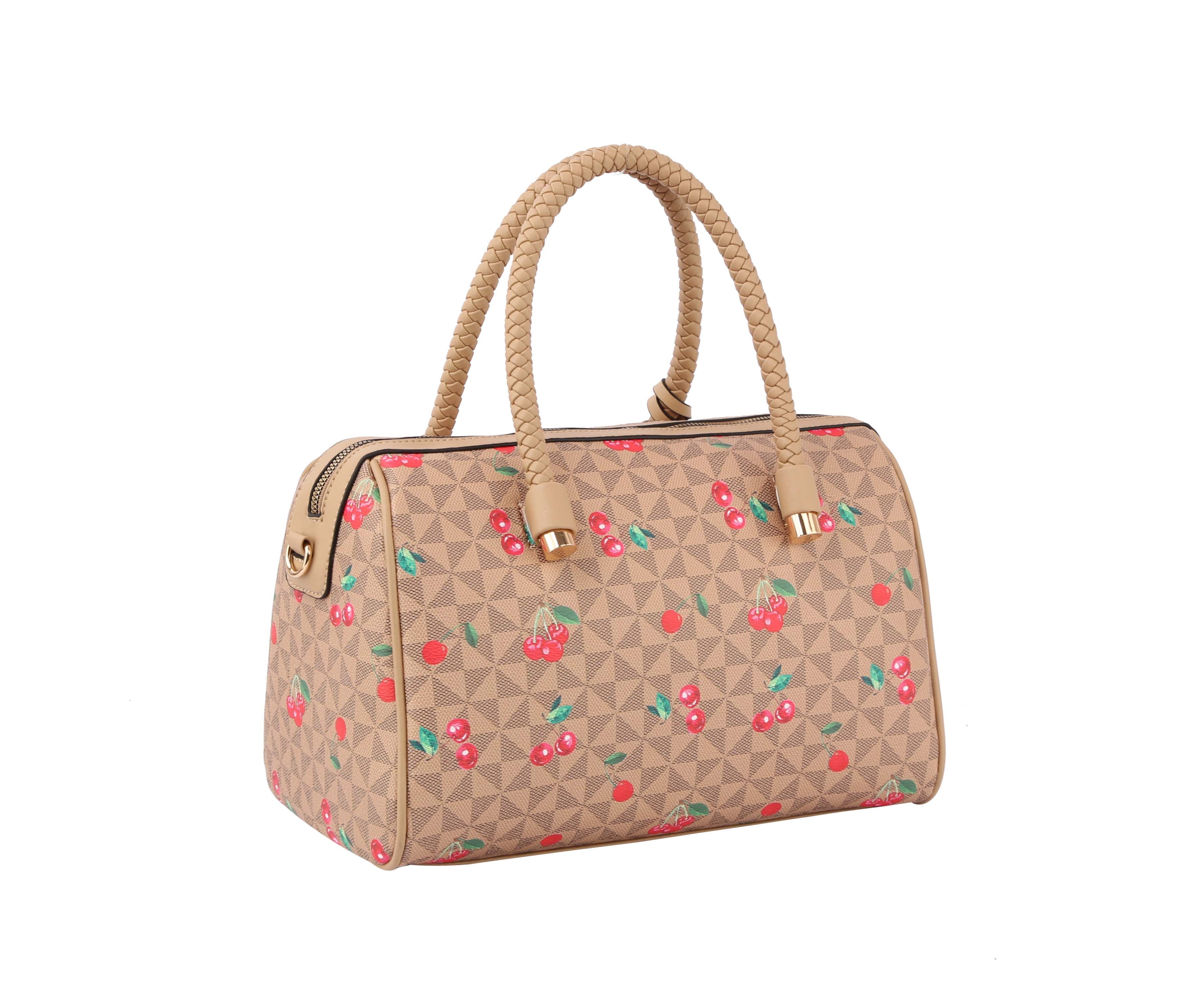 The Signature Cherry Print Satchel Set features a beige faux leather bag with a geometric pattern and red cherry prints, gold-accented braided handles, zipper closure, detachable strap, and a structured shape for versatile carrying options.