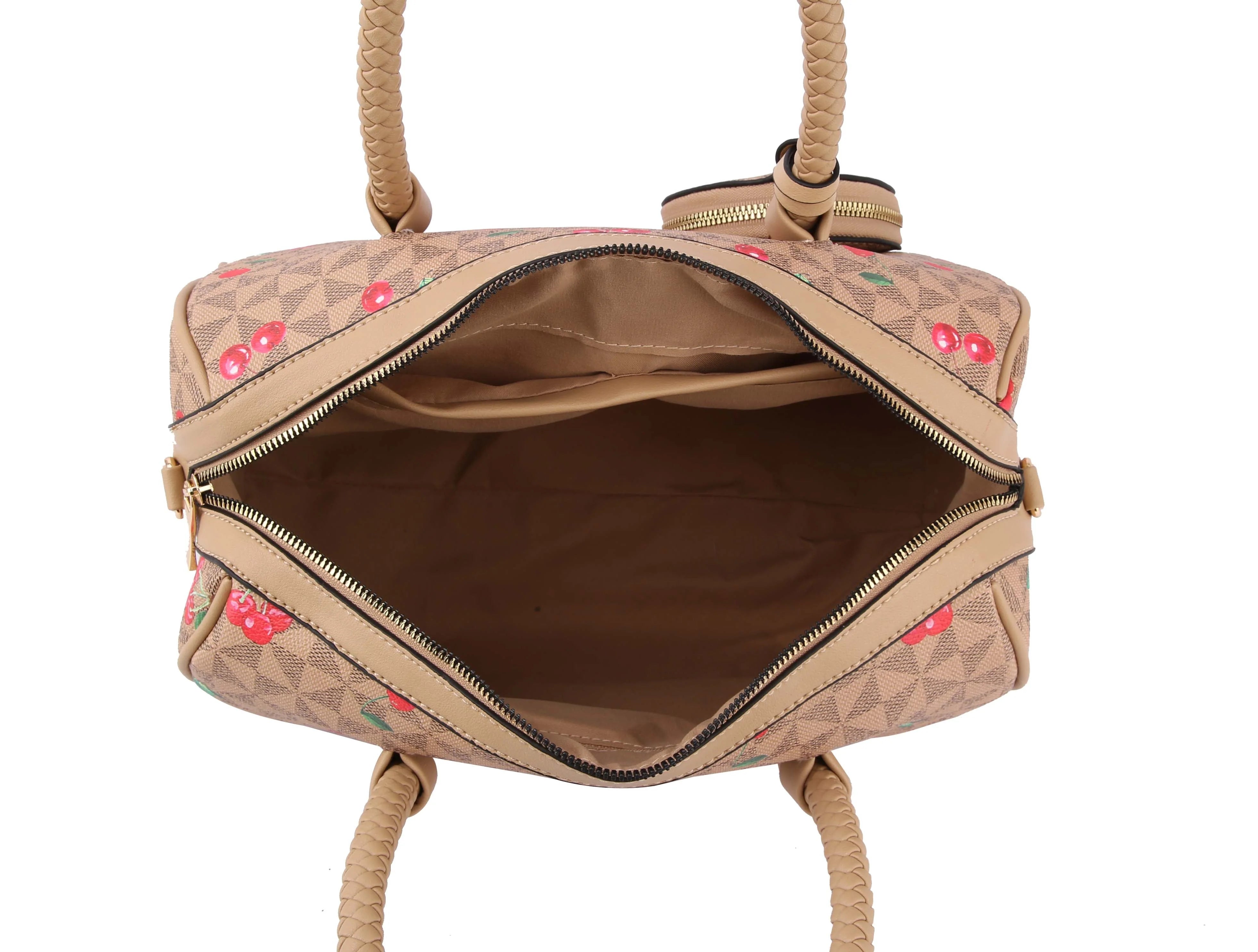 A top view of the Signature Cherry Print Satchel Set: an open beige faux leather bag with tan braided handles, a detachable strap, red cherry patterned exterior, and a spacious light brown fabric-lined interior.