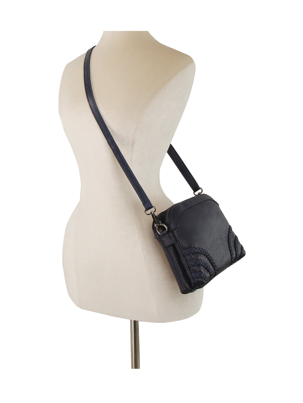 The Braid Accented Clutch Crossbody Bag in black faux leather, featuring an adjustable strap and dual top zip closure, is displayed on a beige dress form mannequin against a white background.