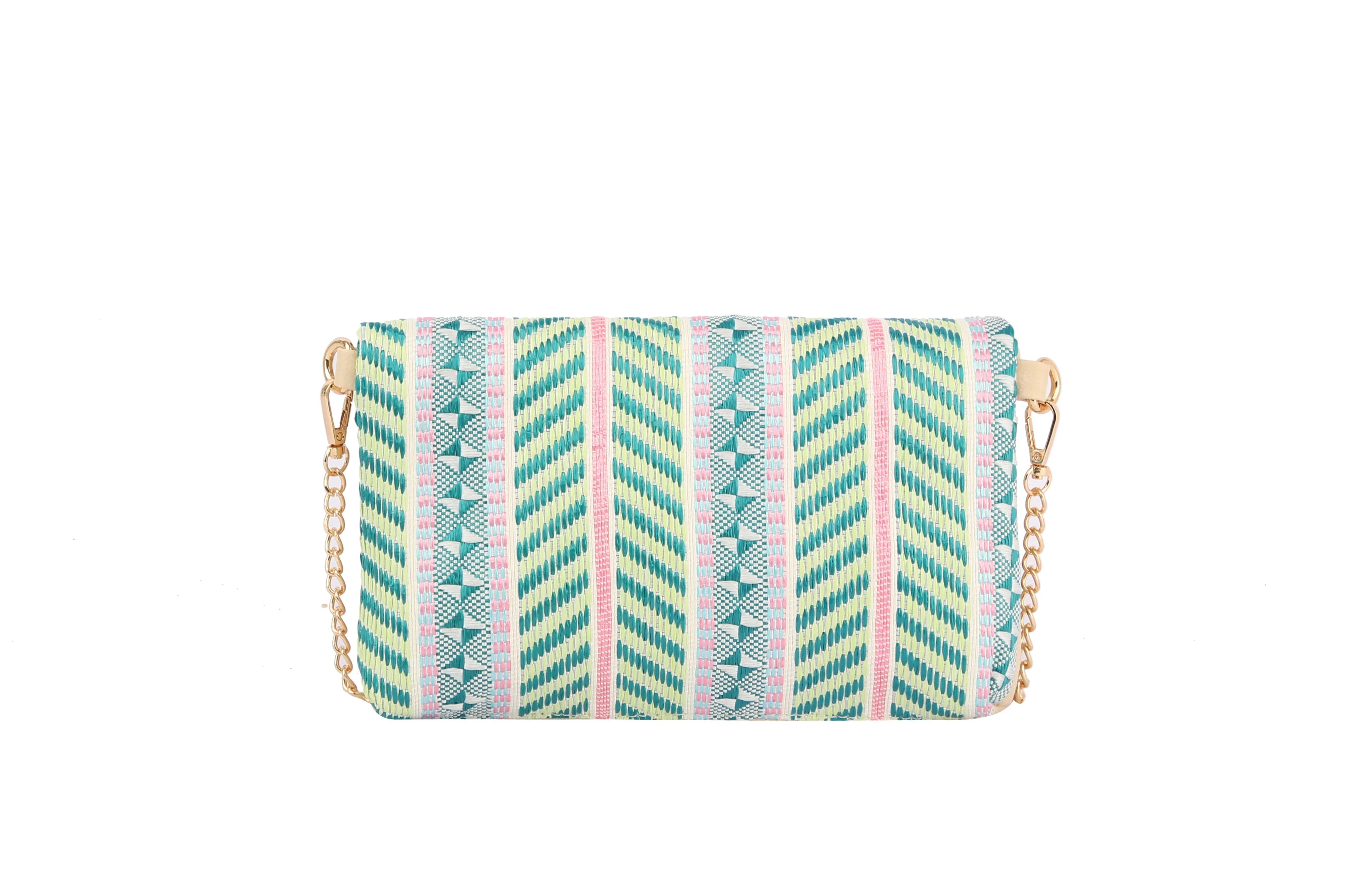 The Colorful Woven Crossbody Bag is a small faux leather purse with a gold chain strap and a pastel geometric pattern in teal, pink, and yellow on a white background.
