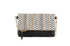 The Colorful Woven Crossbody Bag features a black faux leather base, a white, black, and gold geometric flap, gold-tone hardware, chain strap accents, and a stylish black tassel.
