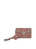 The Heart Print Tri Fold Wristlet Wallet is a brown faux leather wallet featuring a wristlet strap, pink fluffy pom-pom, red, pink, and white heart prints, a silver heart-shaped button on the flap, and multiple interior card slots.