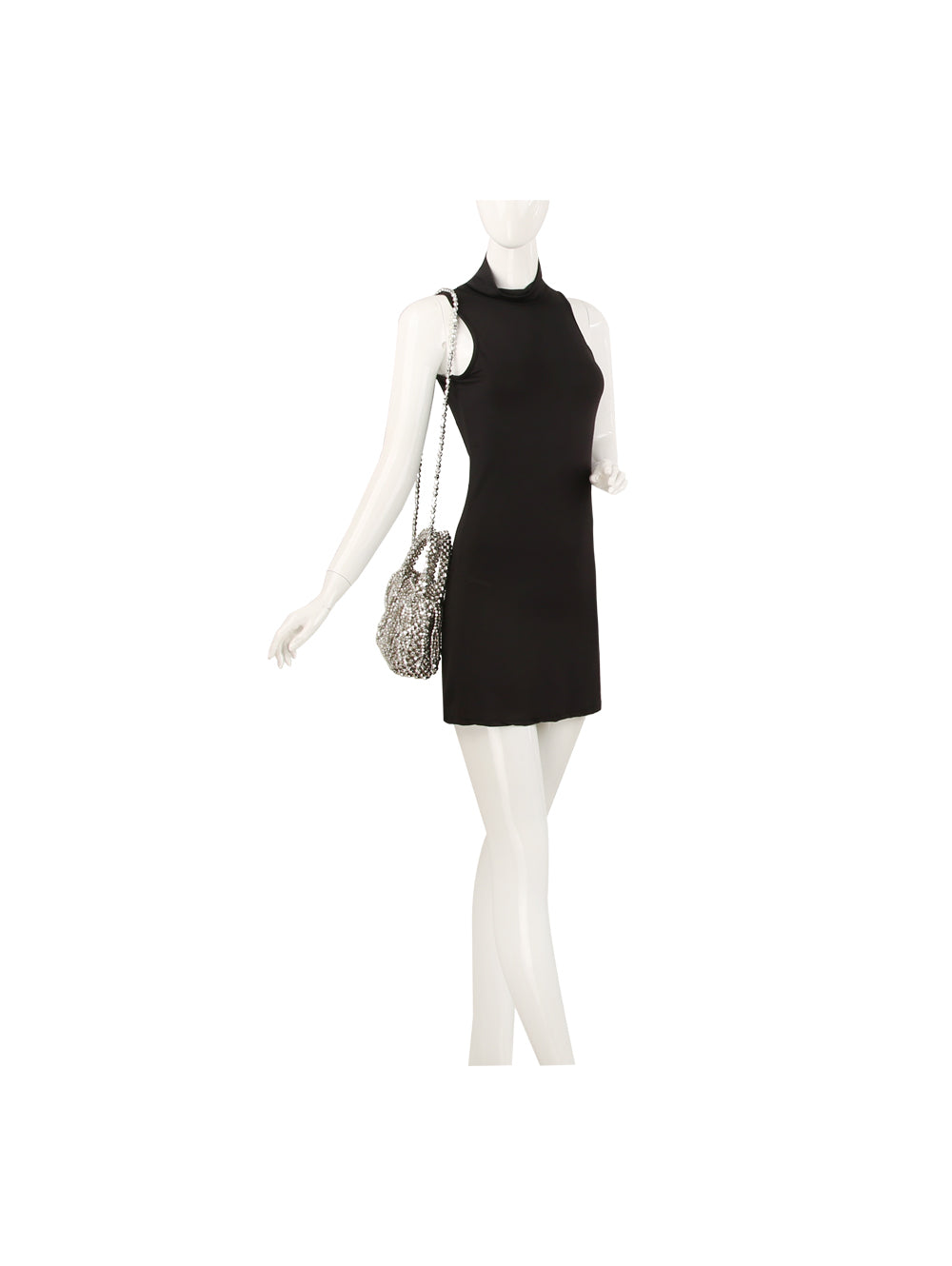 A mannequin wearing a sleeveless, high-neck black mini dress and carrying the Pearl Beaded Tassel Detailed Evening Clutch—a small, silver handbag with a detachable crossbody strap—on its shoulder.