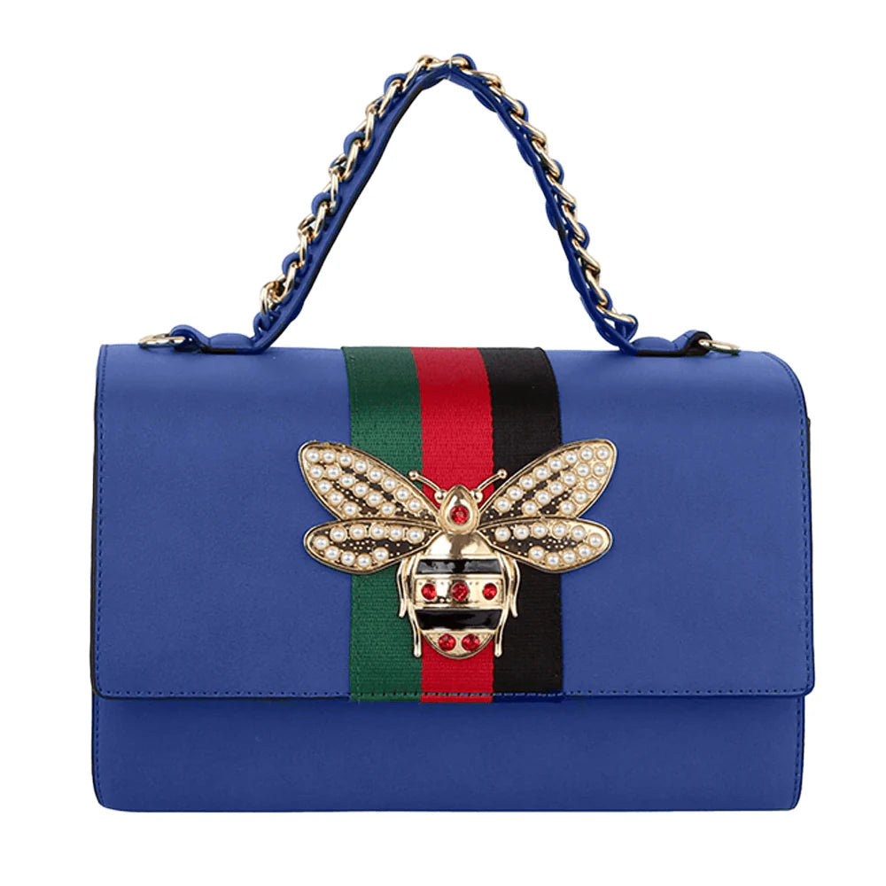 The Bee Pendant Patent Satchel Handbag Set includes a blue faux leather bag with gold-toned hardware, a jeweled bee ornament, vertical red and green center stripes, and a matching wallet.