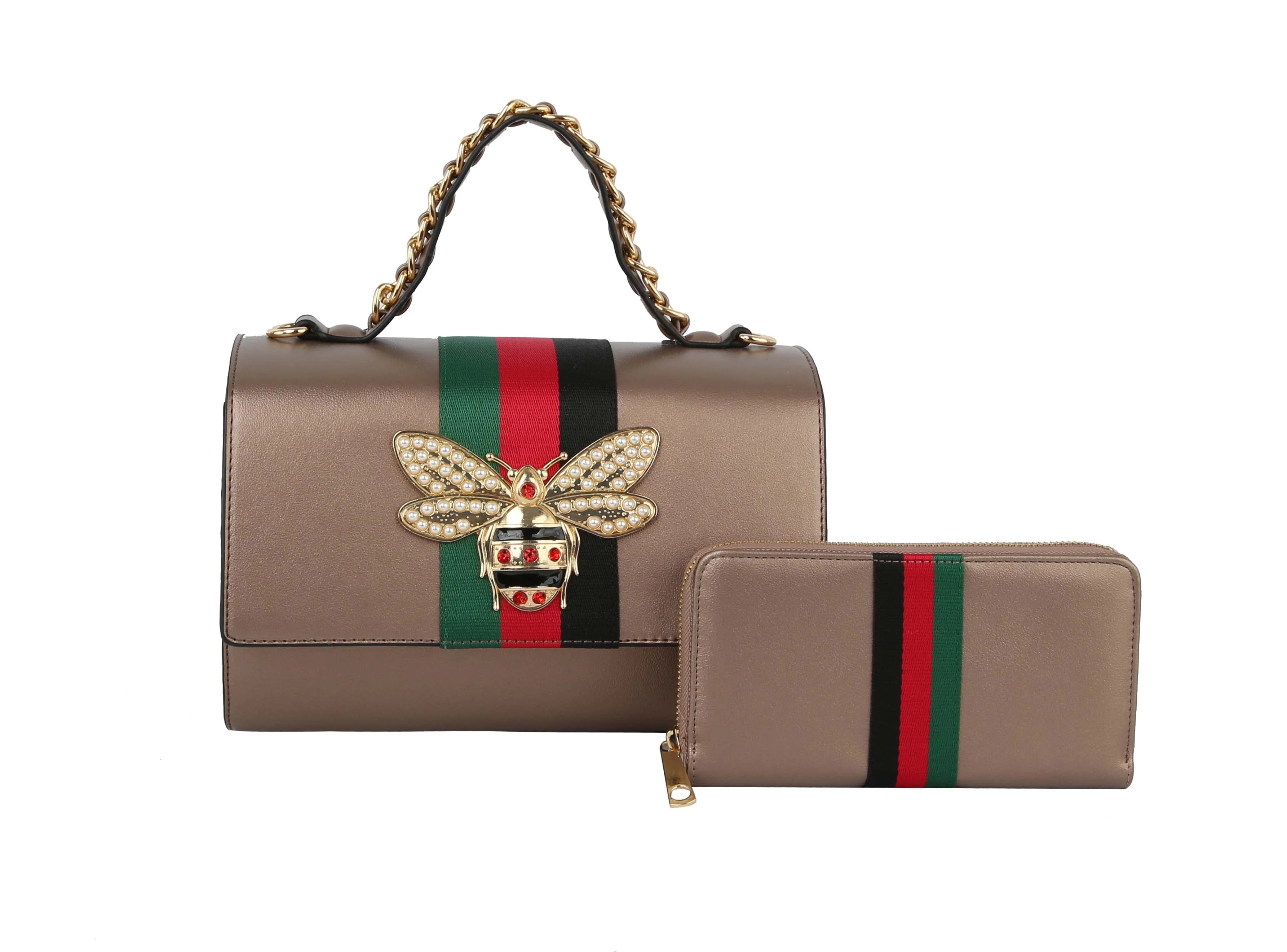 The Bee Pendant Patent Satchel Handbag Set features faux leather with a charming bee pendant, gold-toned hardware, and a matching wallet.